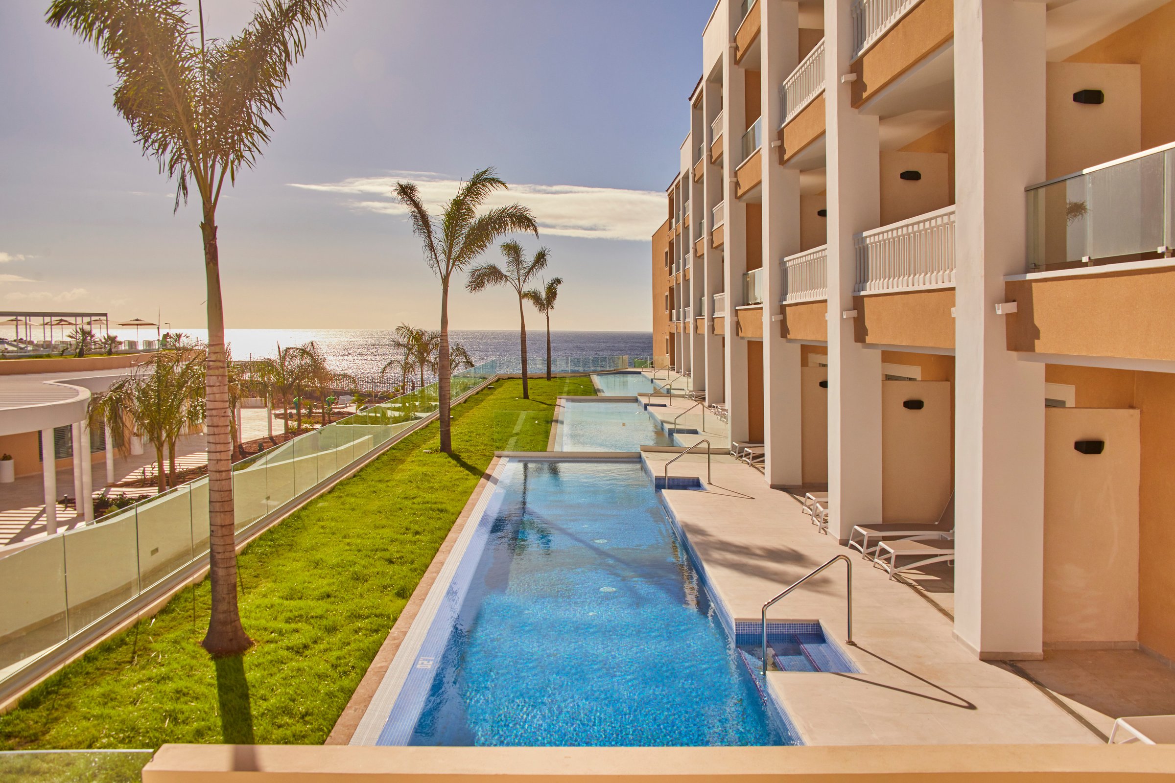 Row of swim-up suite pools toward the ocean