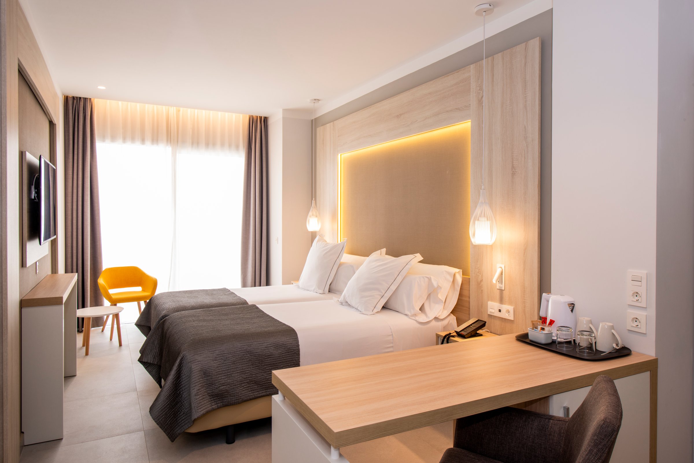 Double room with desk, armchair and balcony windows