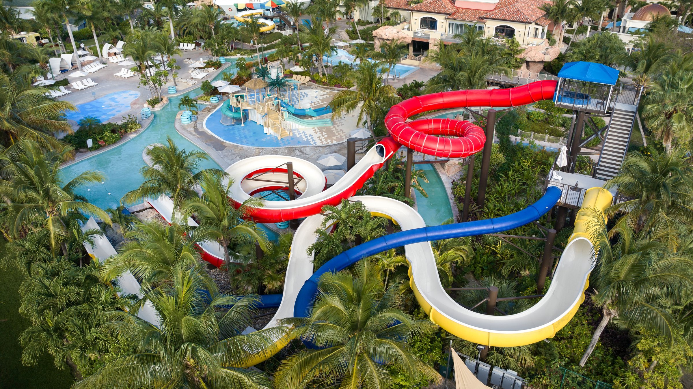 Colourful waterpark slides among palms and pools at Beaches Turks & Caicos