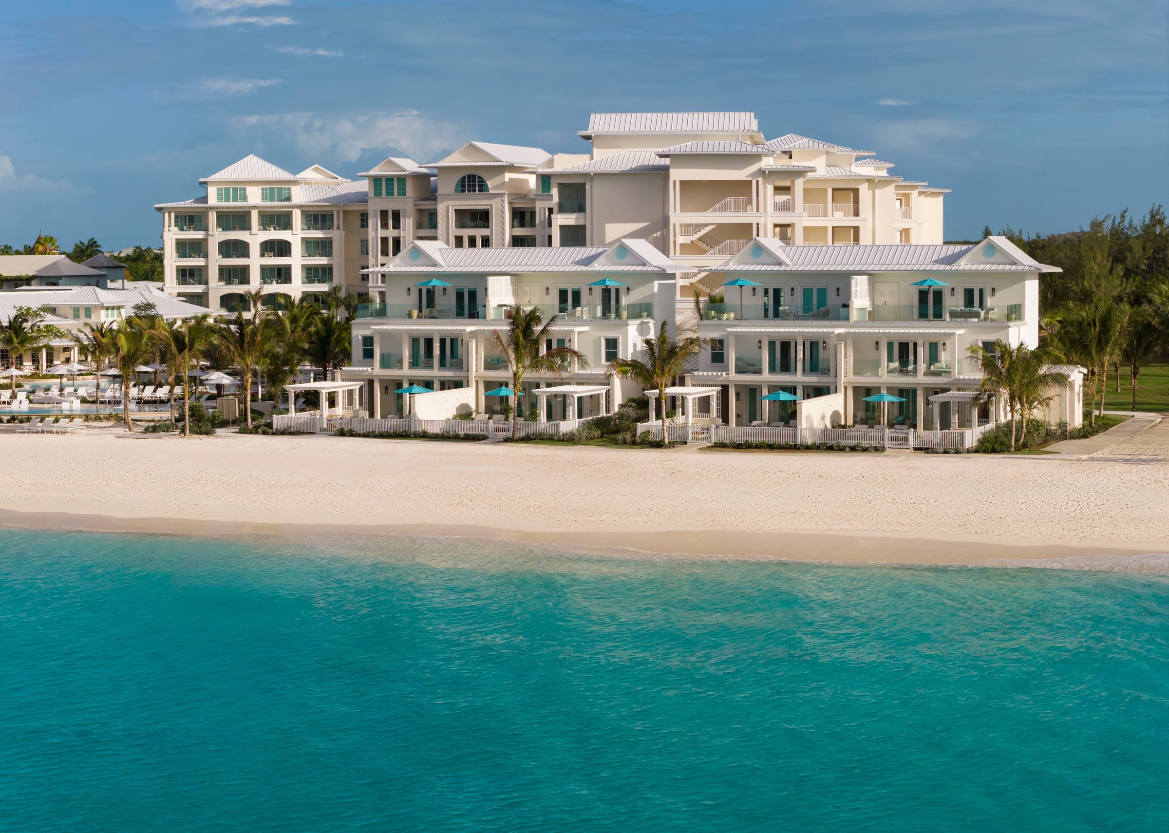 Treasure Beach Village suites on the beach above clear turquoise water.