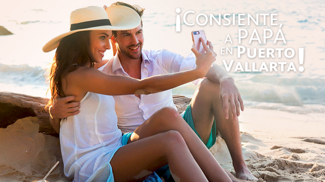 Couple in straw hats taking a selfie on the beach at sunset, with ocean waves in the background.