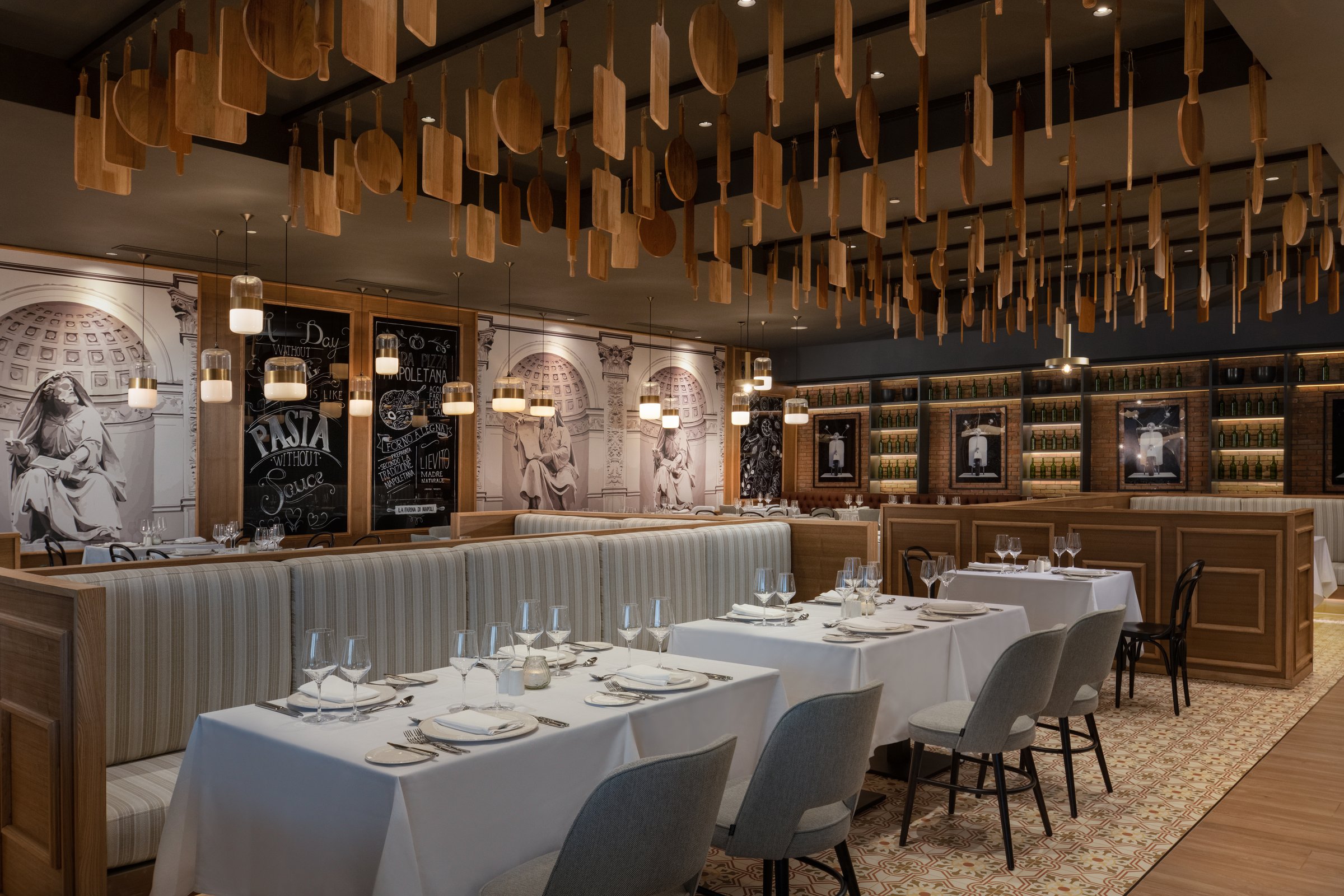 Portofino Italian restaurant with pizza-peel ceiling and green-bottle shelving.