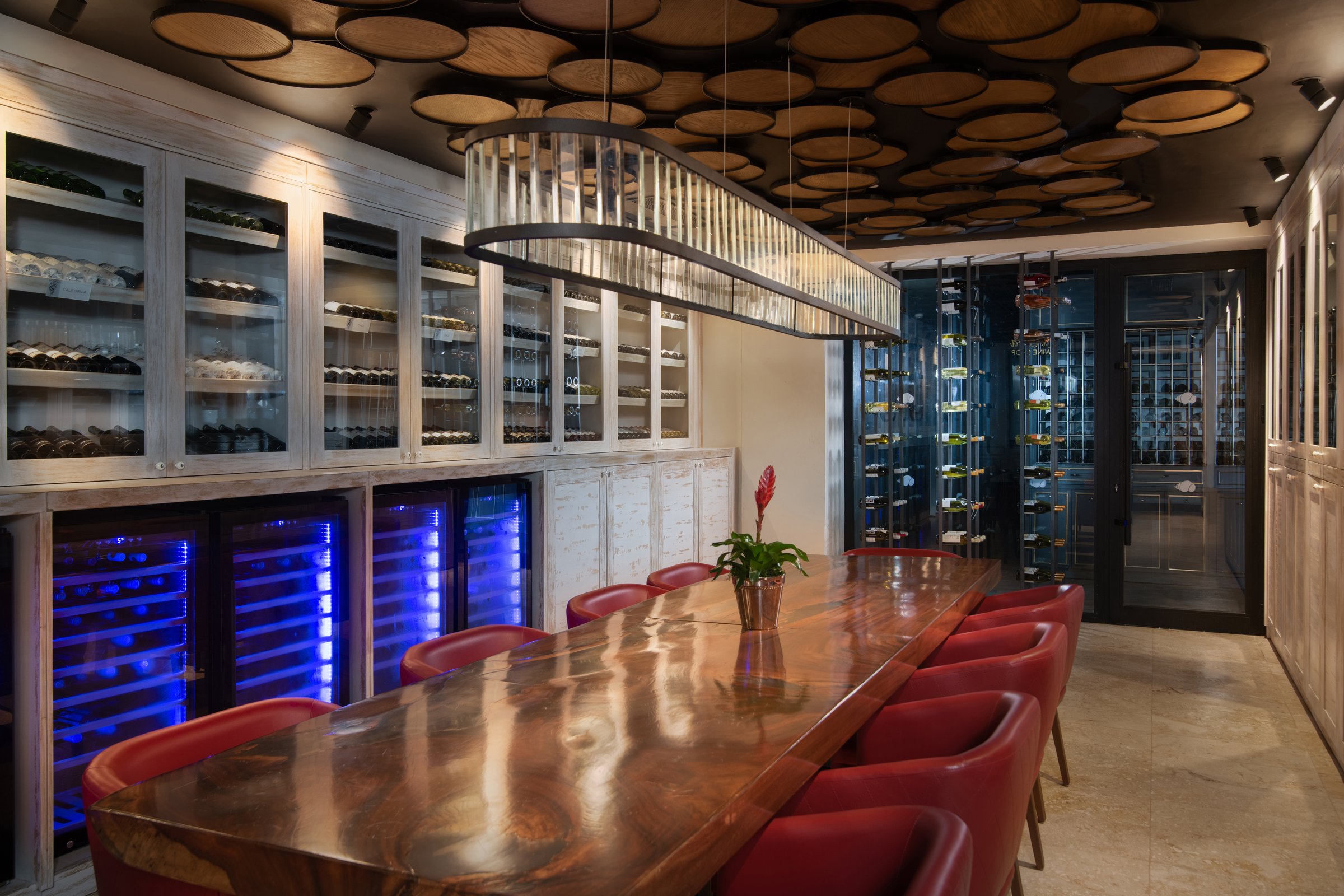 La Cava private dining room with live-edge table and wine cabinets.