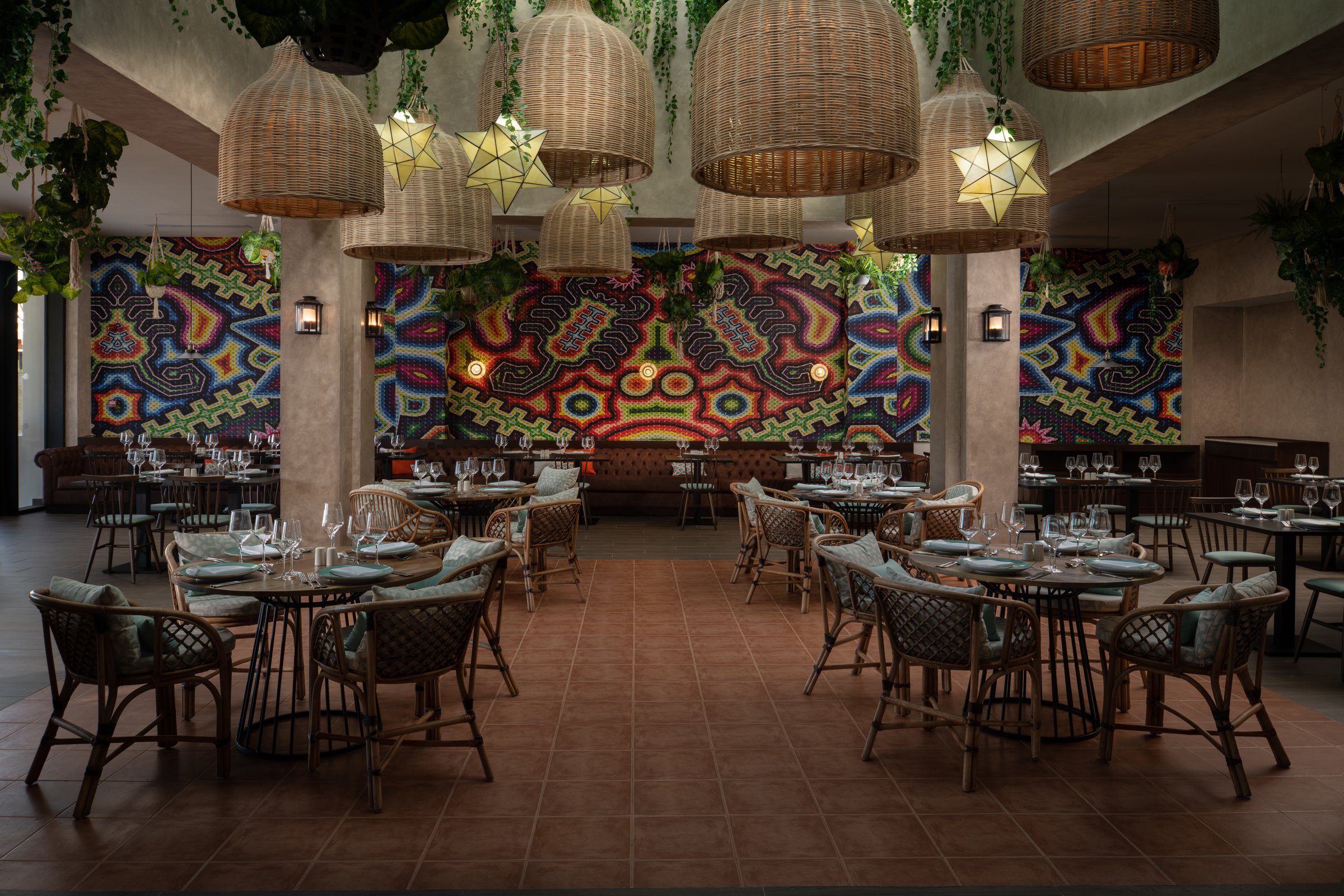 El Patio dining room with a colorful beaded-style mural wall.