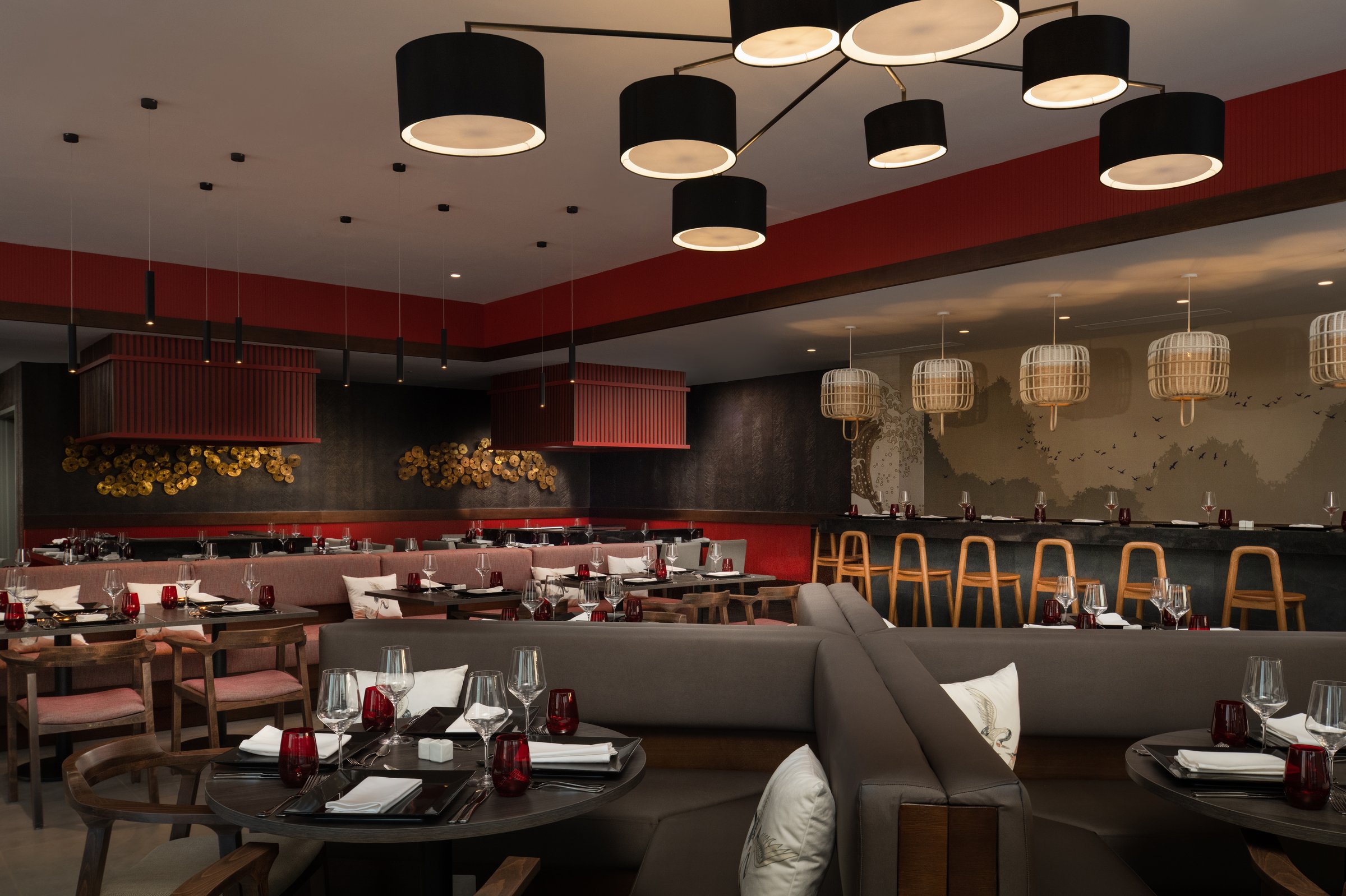 Himitsu Asian restaurant with banquettes, sushi counter and red accents.
