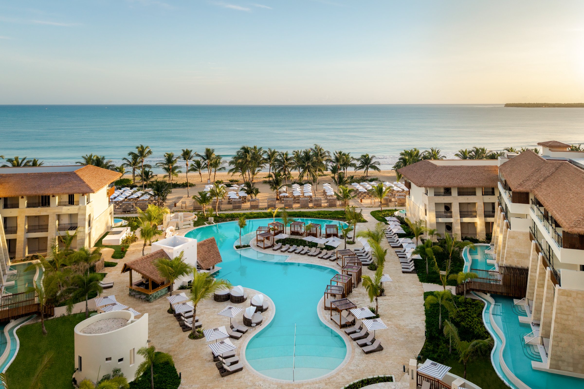 Aerial of the multi-lobed Preferred Club pool and swim-up bar facing the beach and sea.