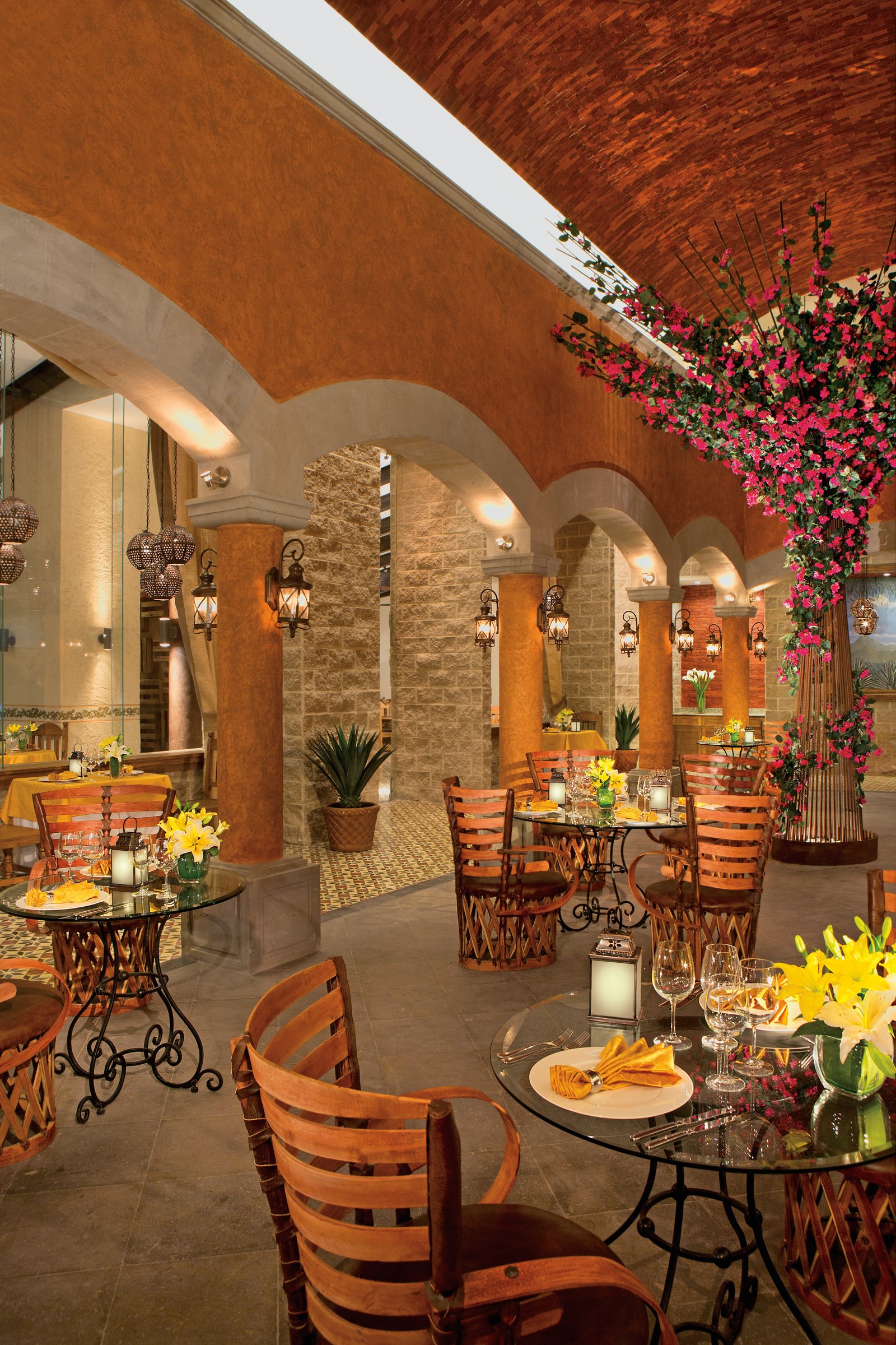 Tamarindo hacienda-style dining room with terracotta arches and a brick vaulted ceiling.