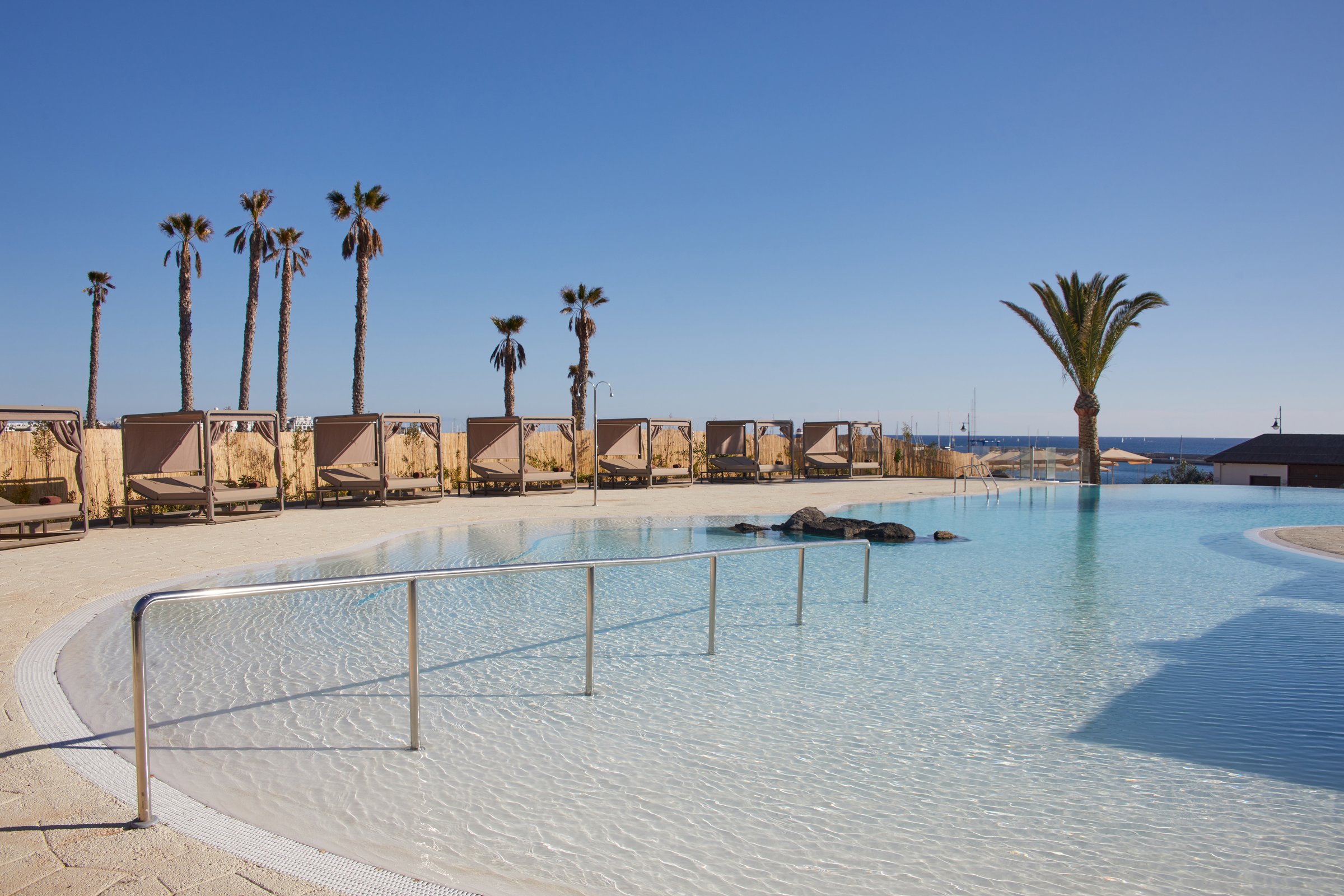 Elysian lagoon-style pool with cabanas