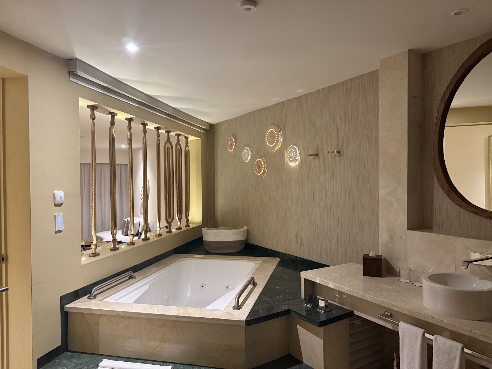Spacious bathroom with a sunken soaking tub, double vanity, and illuminated mirror wall at Grand Park Royal Cancún.