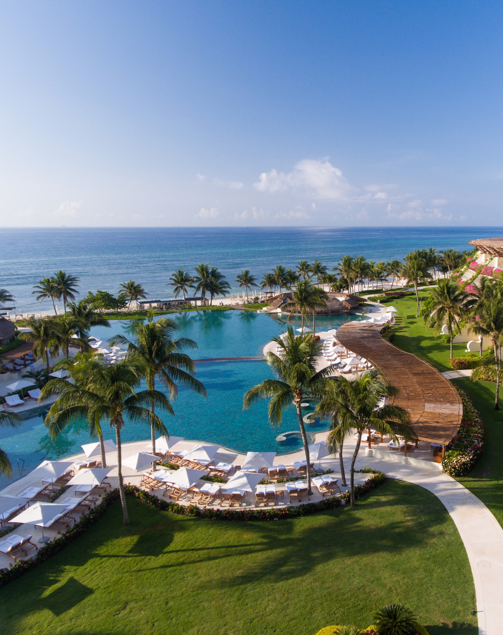 Spa hot tub with turquoise water and purple mood lighting, bordered by black marble walls at Grand Velas Riviera Maya.