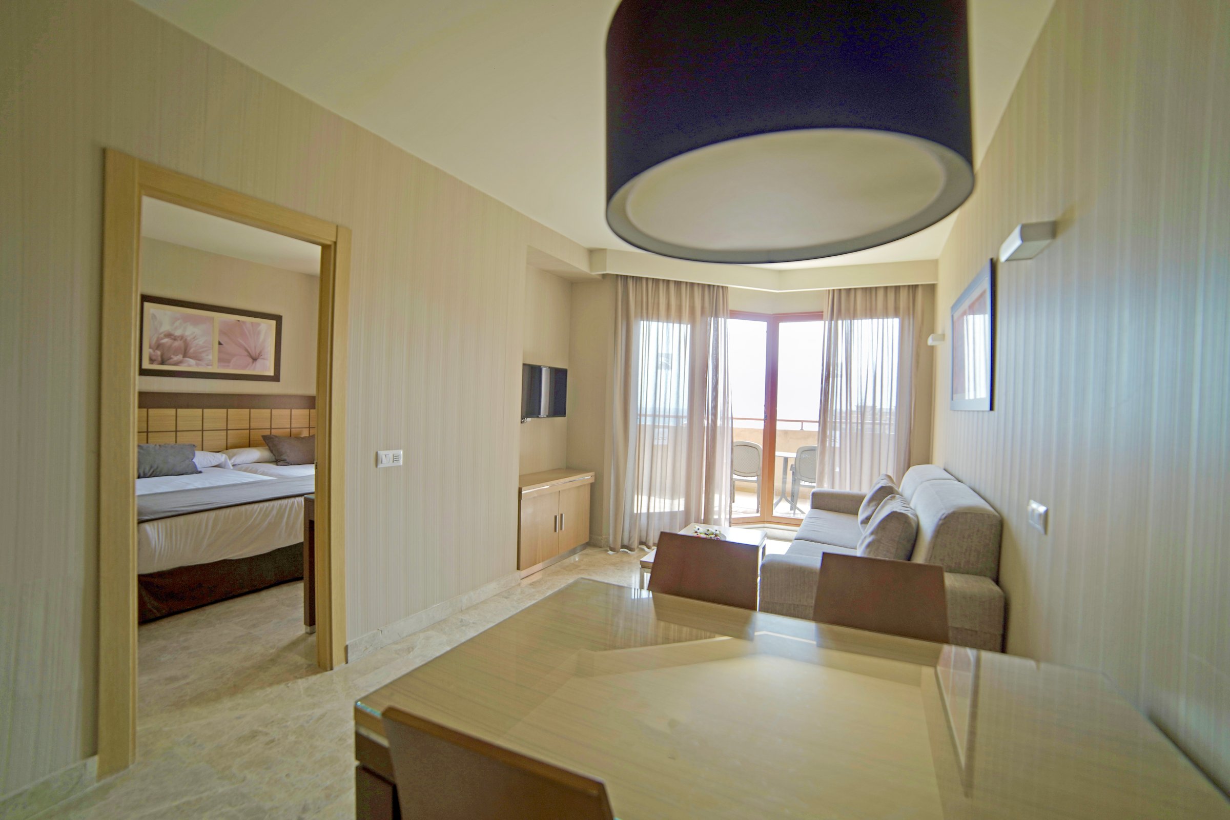 Junior suite living and dining area with balcony