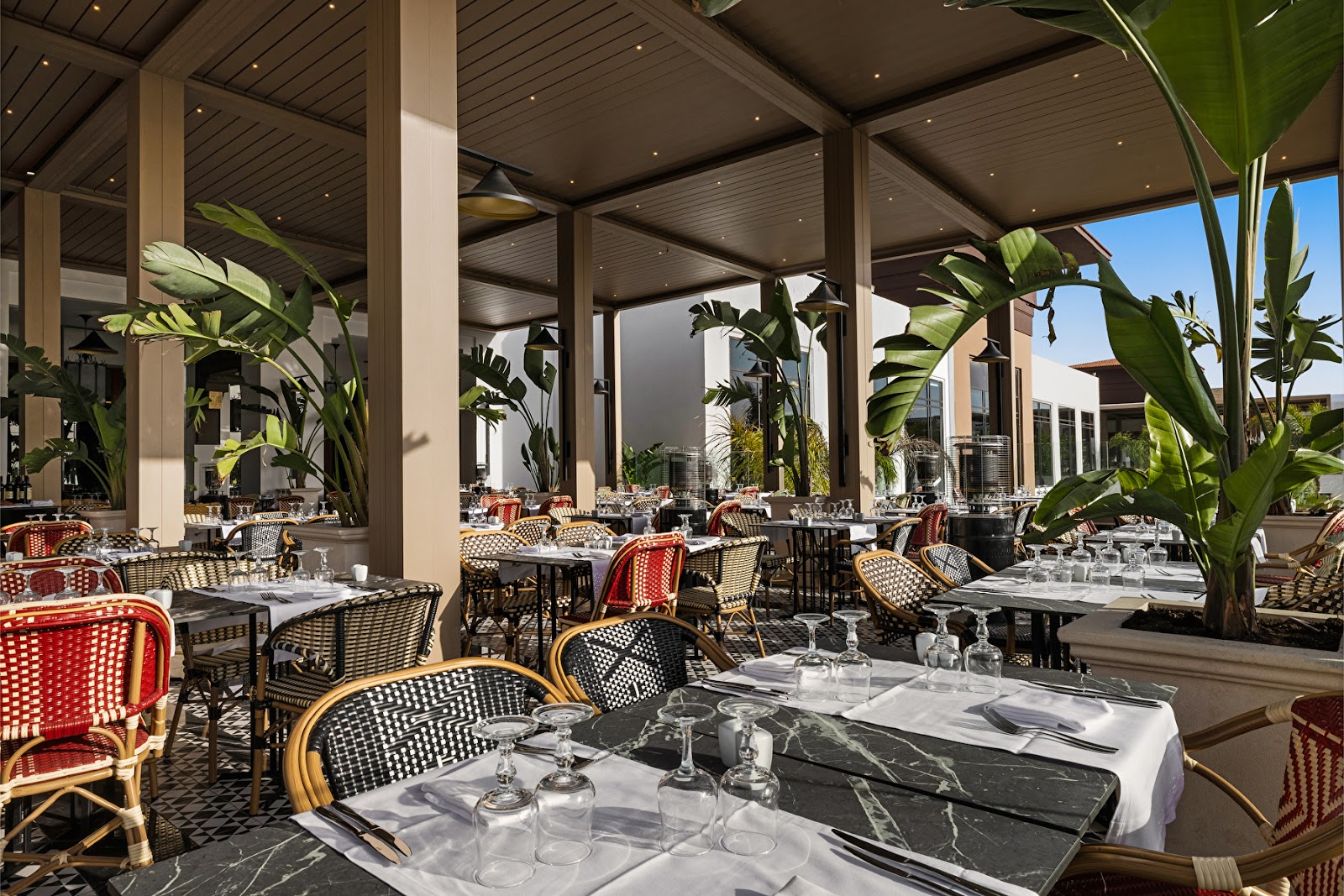 Spa lobby with symmetrical seating, polished dark floors, brass pendant lights, and a central water feature at Hotel Riu Palace Tikida Agadir.