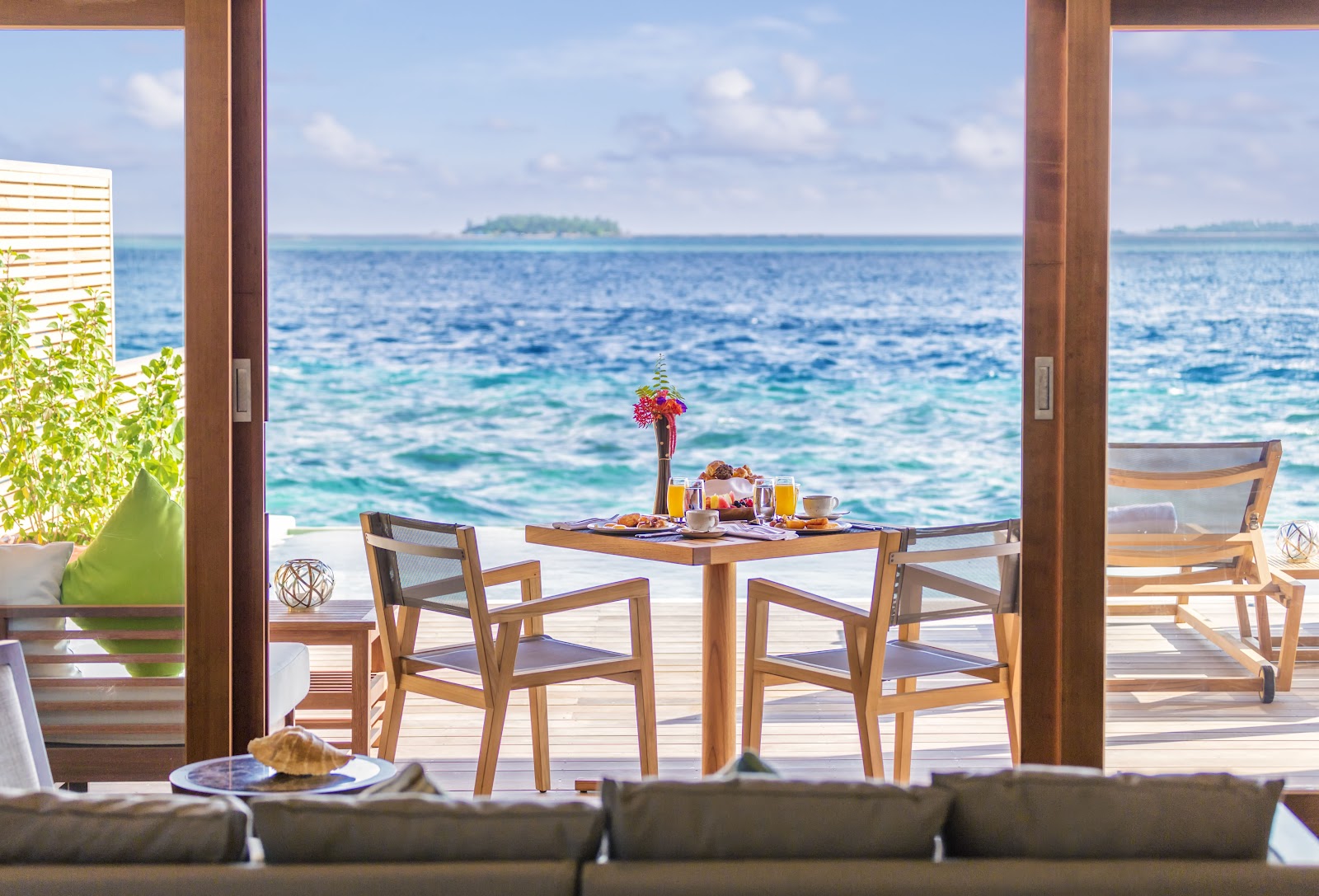 Private villa with turquoise pool, white sand beach, and lush tropical vegetation at Hurawalhi Island Resort.