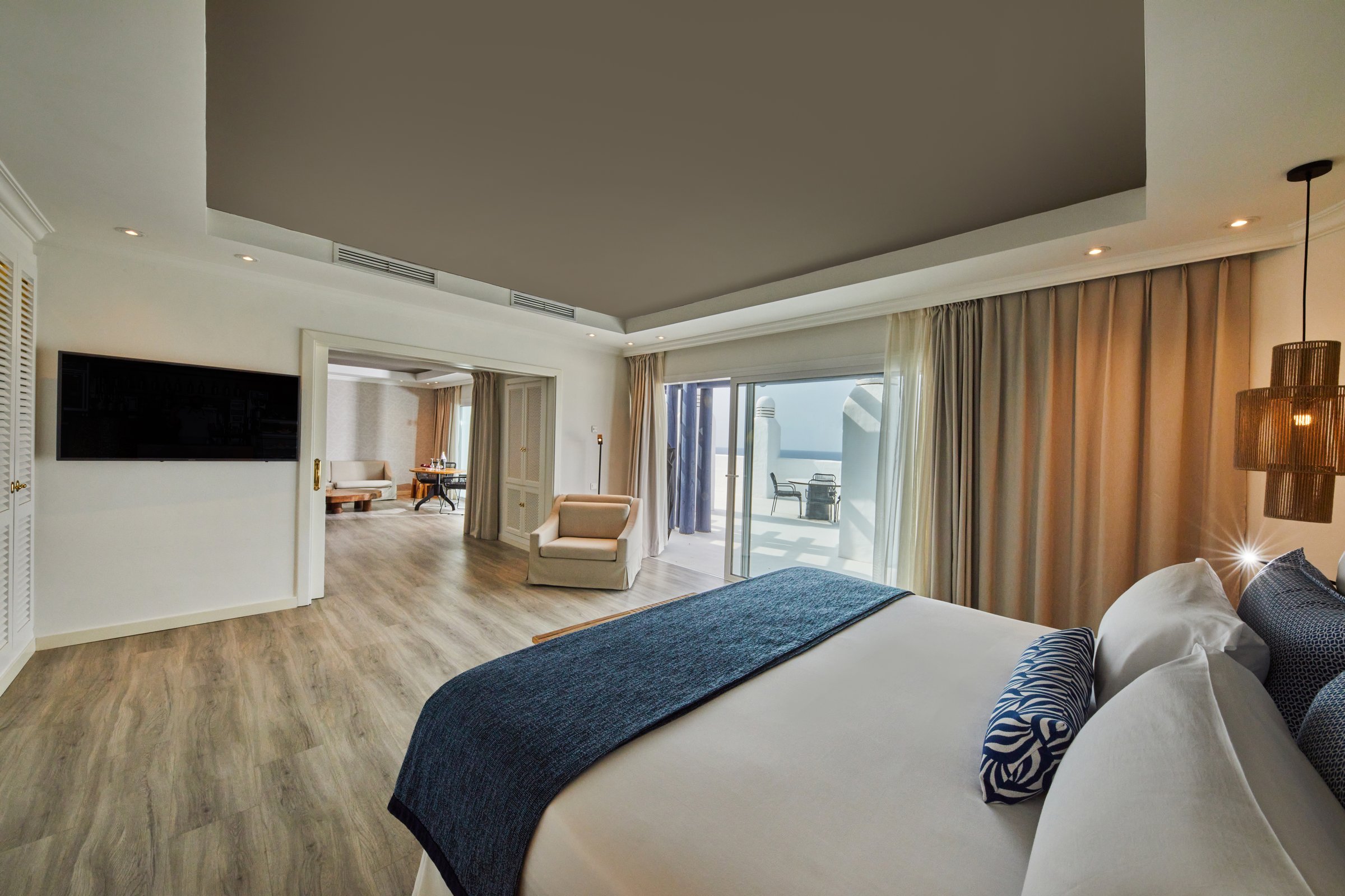 Spacious suite with bedroom, separate living area and balcony with sea view.