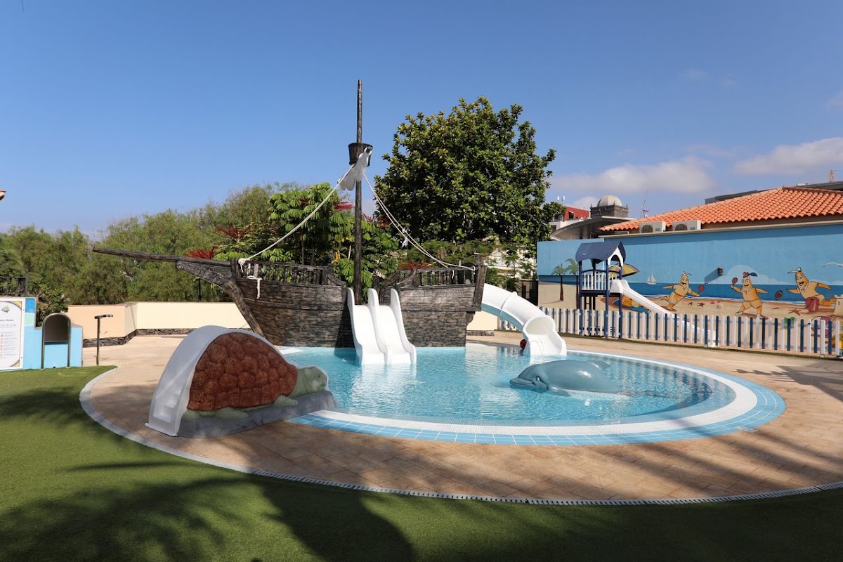 Pirate ship-themed children's pool with white slide and turtle sculpture at Iberostar Selection Anthelia.