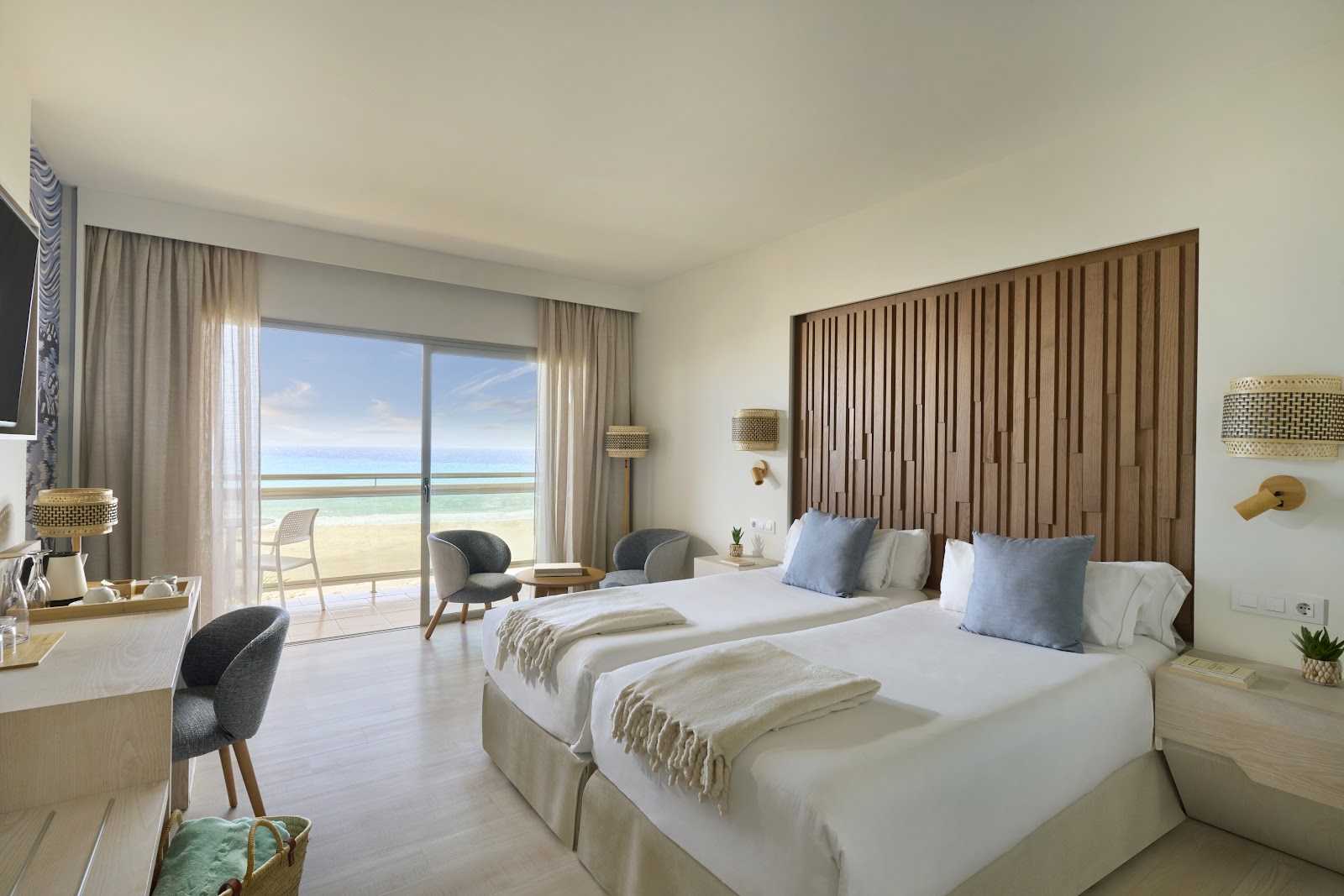 Double beds in a bright beachfront room at Iberostar Selection Fuerteventura Palace, with ocean views from the balcony.