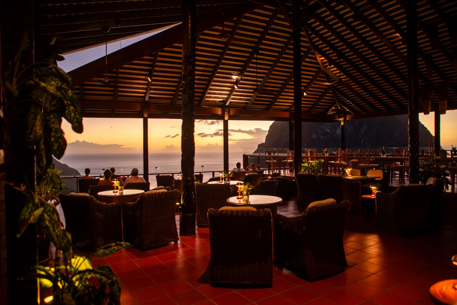 Private pool overlooking the Pitons at Ladera Resort, with loungers and purple bougainvillea on the stone terrace.