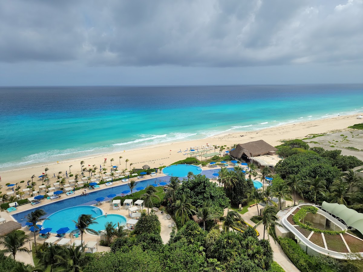 Aerial view of Live Aqua Beach Resort Cancún with multiple pools, palm trees, and white sand beach along turquoise Caribbean waters.