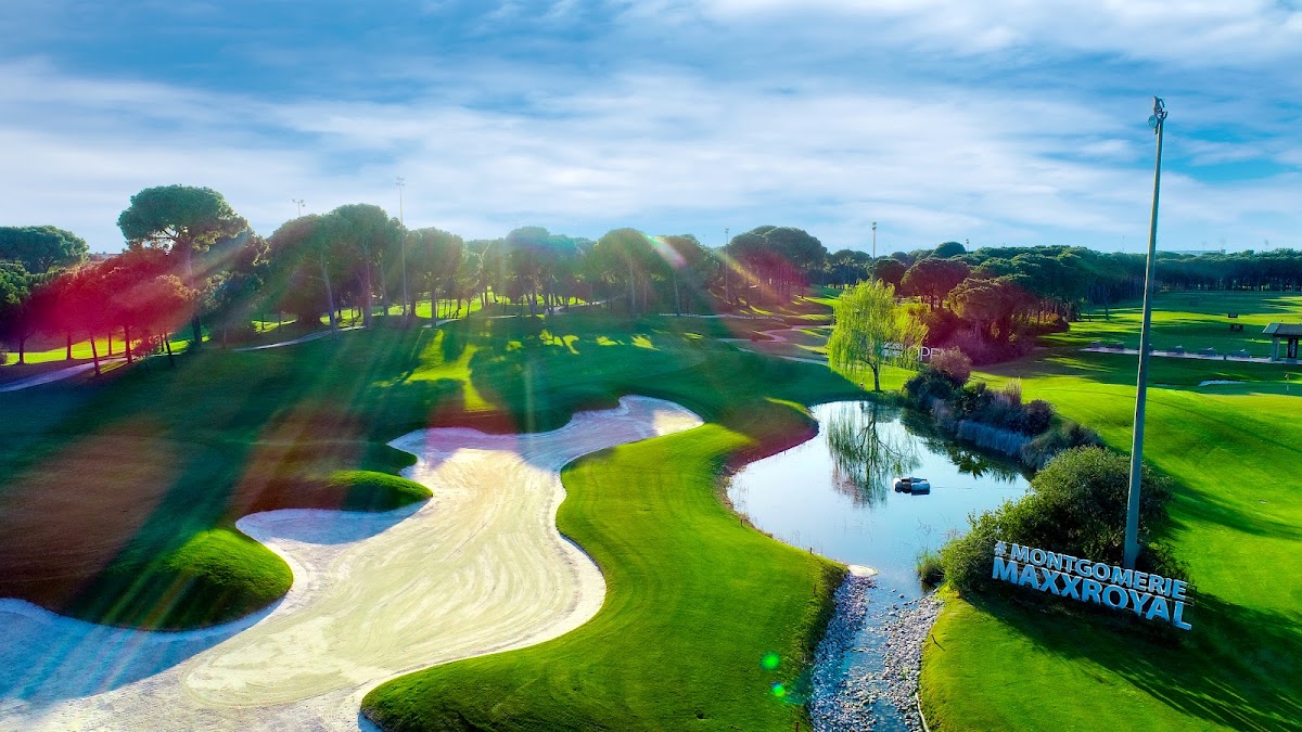 Montgenerie Maxx Royal golf course with manicured fairways, sand bunkers, water hazards, and mature trees lining the greens.