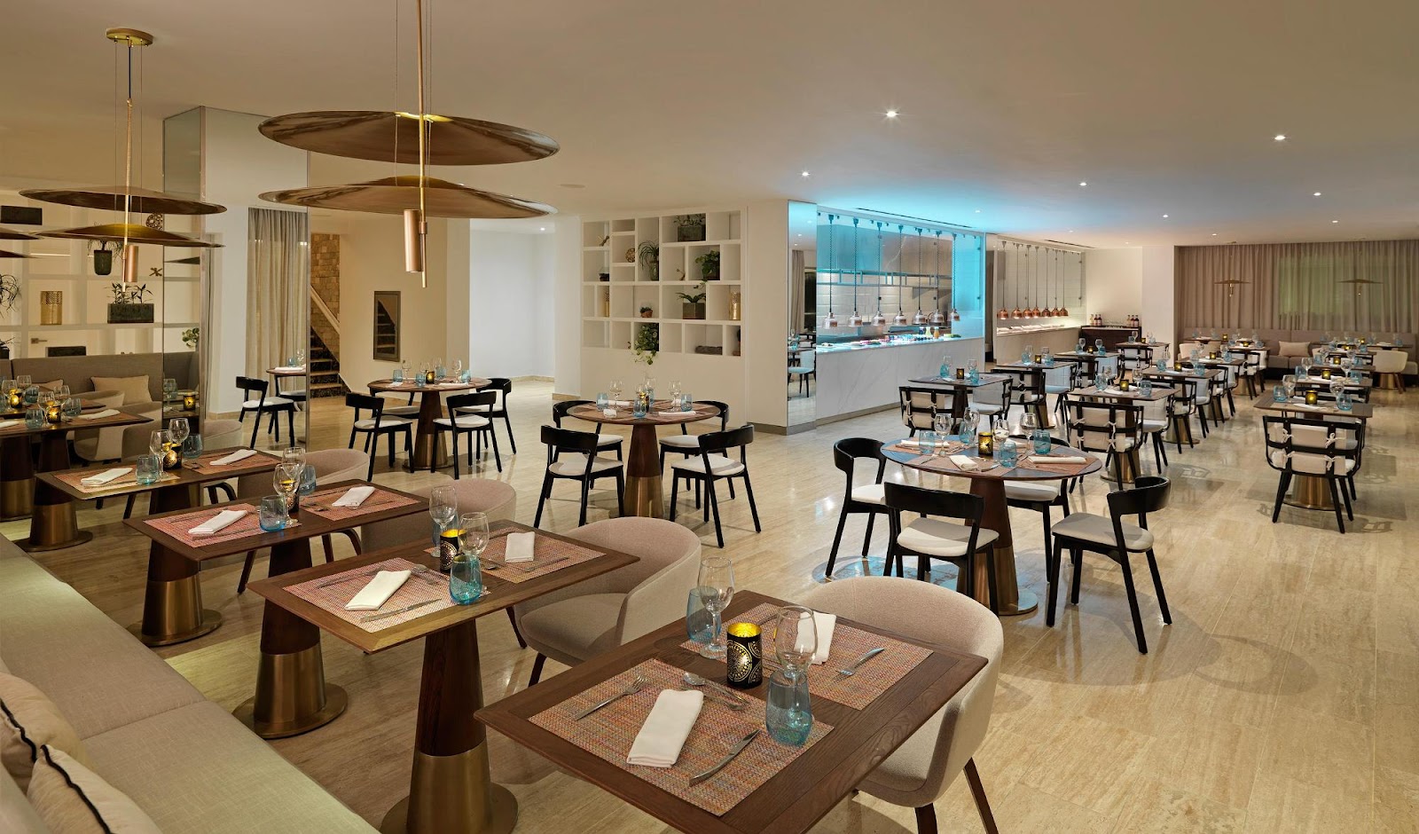 Ballroom with purple lighting, round tables set with white linens and chiavari chairs, projection screens, and bar area at Meliá Punta Cana Beach Wellness Inclusive.