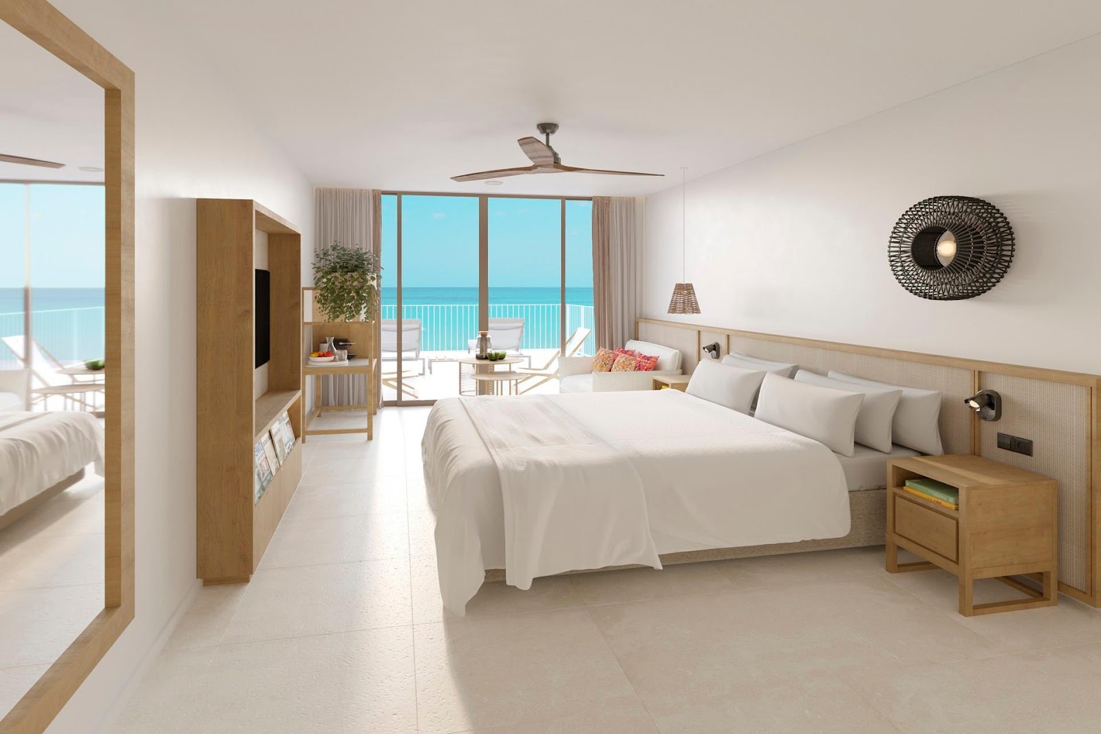 Resort bedroom with king bed, wooden furnishings, and ocean view through glass doors opening to a beachfront balcony.