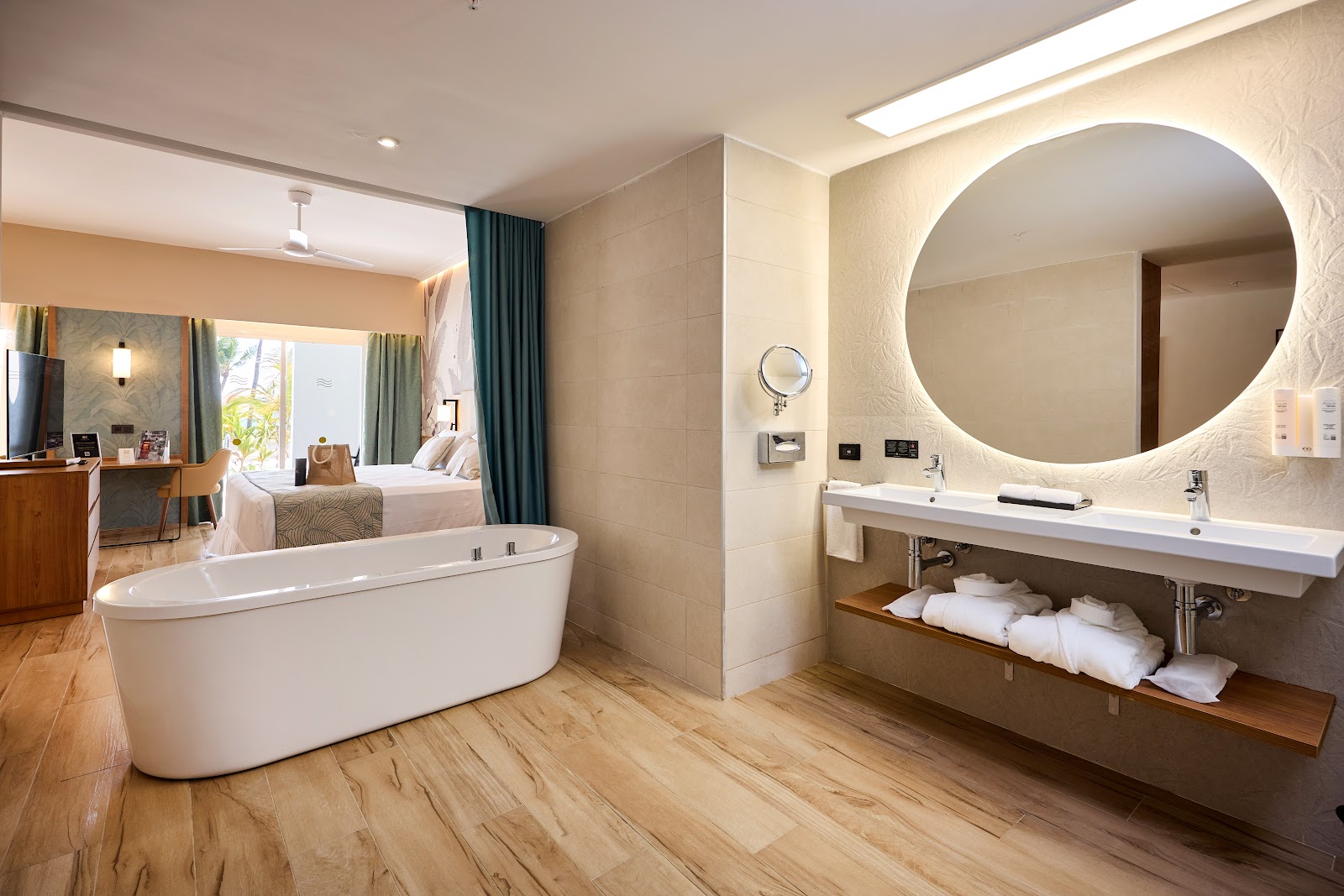 Modern bathroom at Riu Palace Bavaro with dual sinks, soaking tub, walk-in shower, and red accent tiles.
