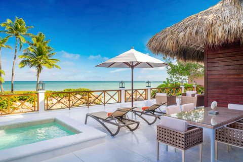 Beachfront bungalow at Sanctuary Cap Cana with private plunge pool, lounge chairs, umbrella, and ocean view.