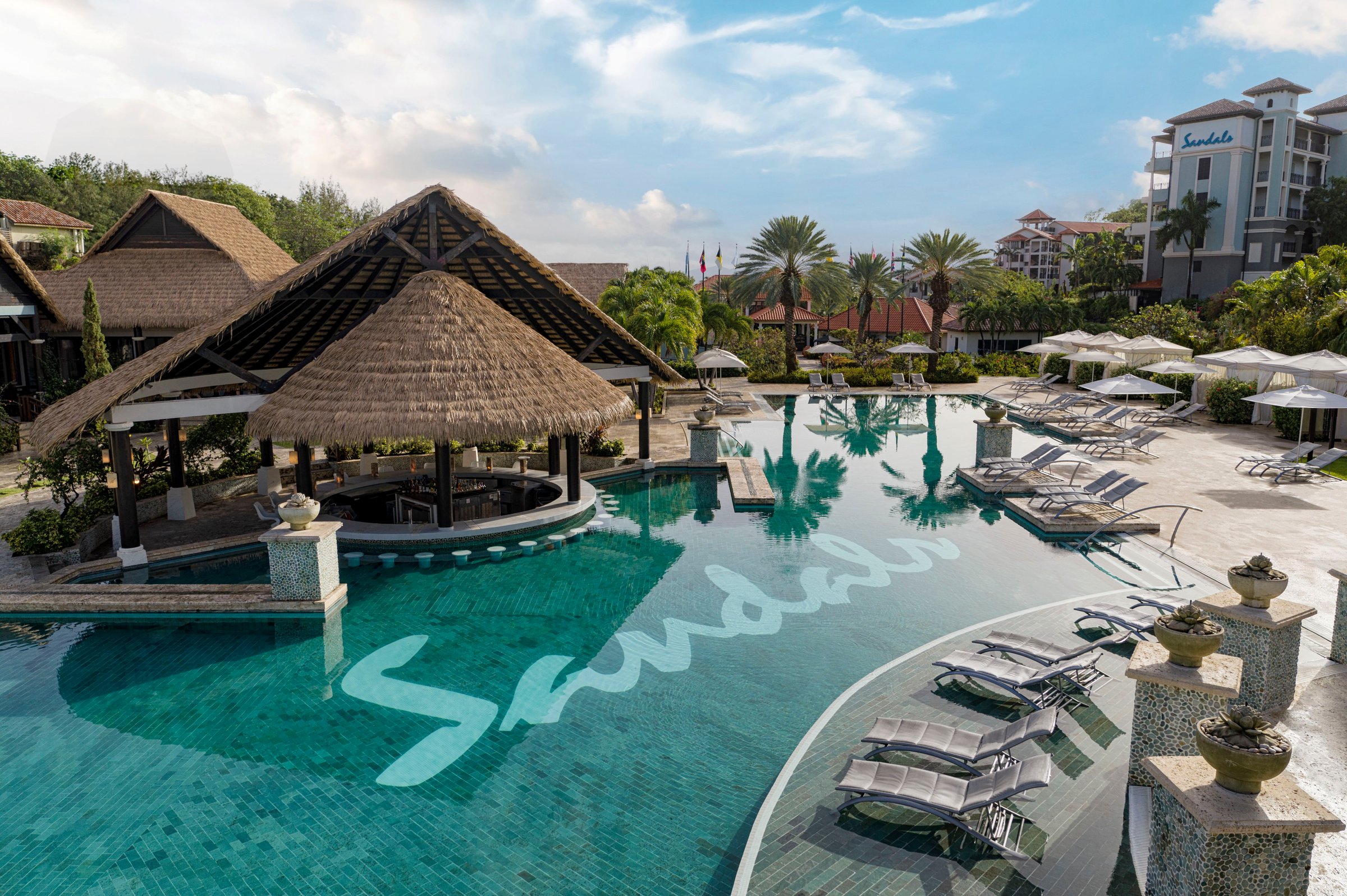 South Seas pool with the Sandals mosaic, thatched bar and loungers.