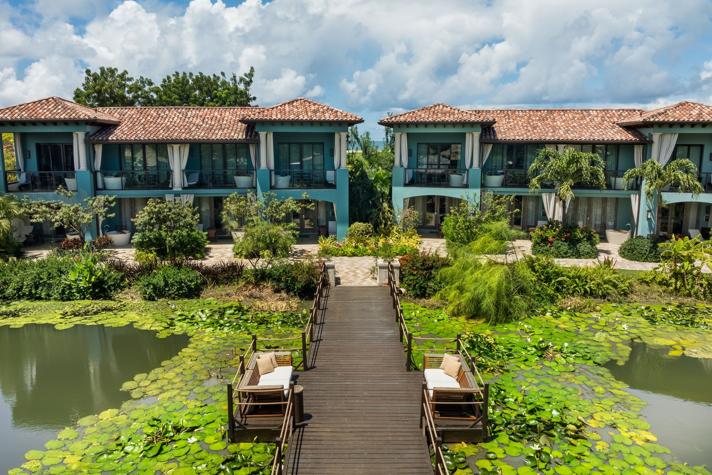 Lovers' Lagoon boardwalk across a lily pond to the suite buildings.