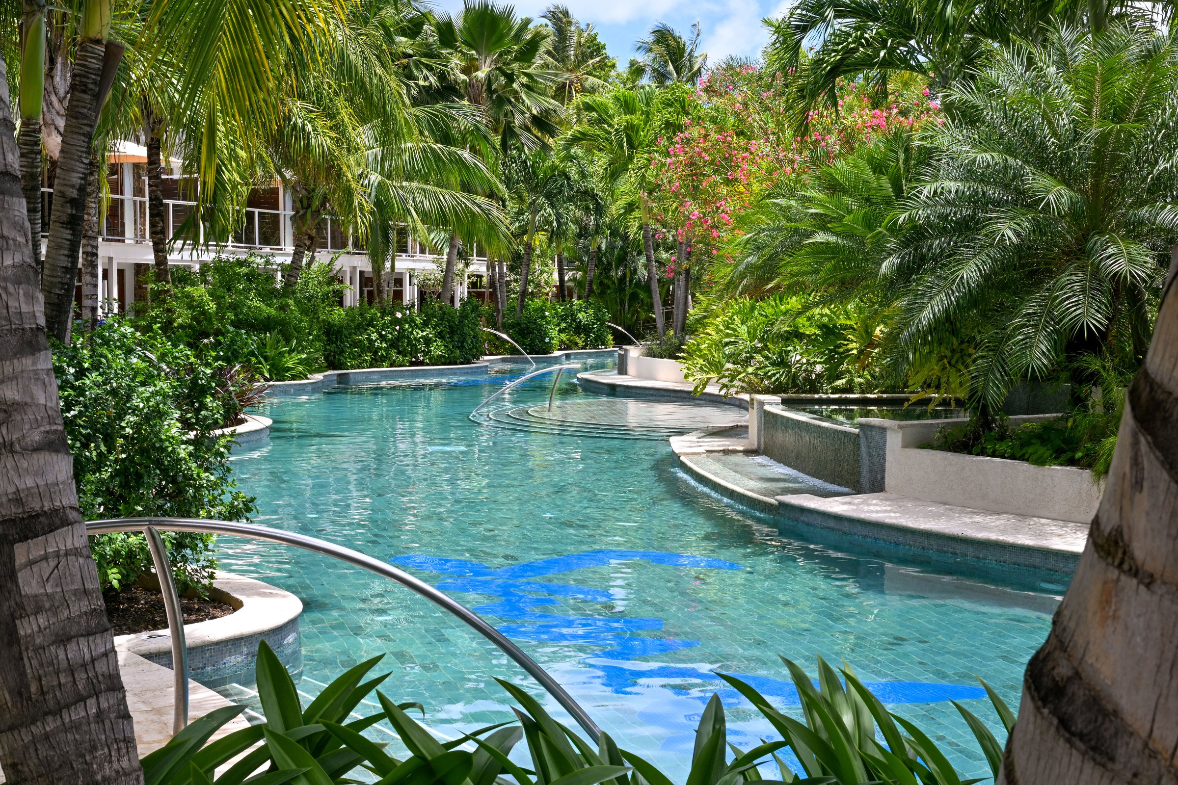 Lazy pool curving past lush gardens and the room blocks.