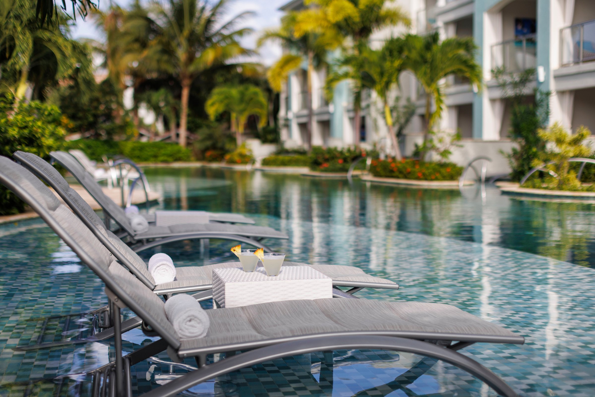 Seagrass pool with in-water loungers beside the suite buildings.
