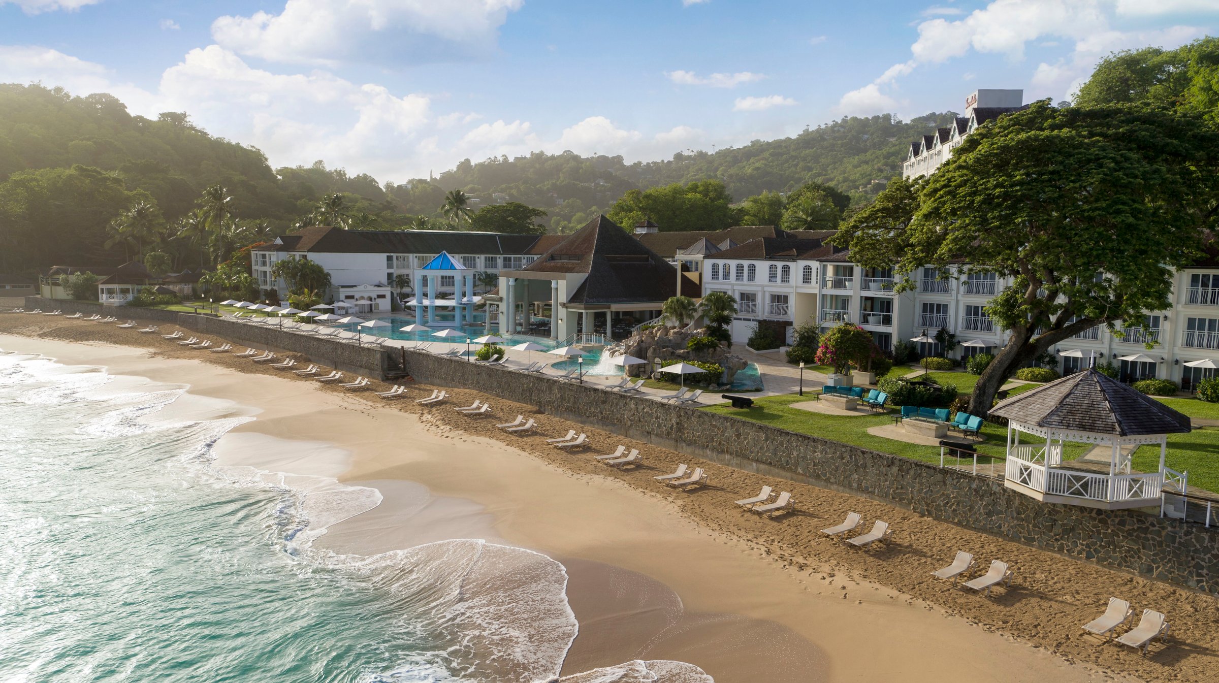 Elevated view along the beach and seawall to the main pool and gazebo.