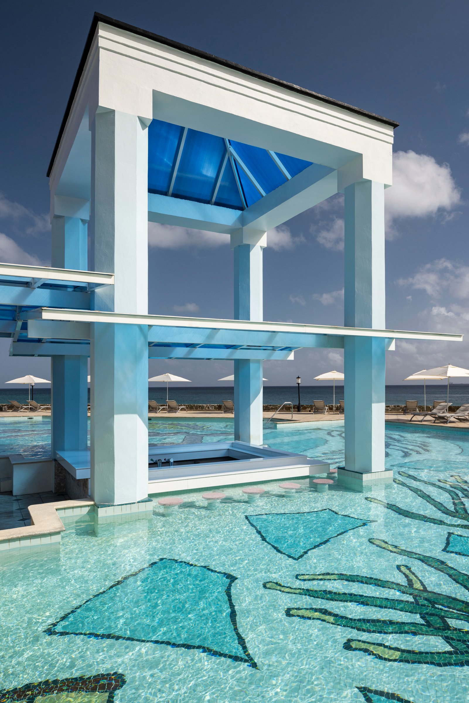 Gazebo swim-up bar rising from the mosaic main pool.