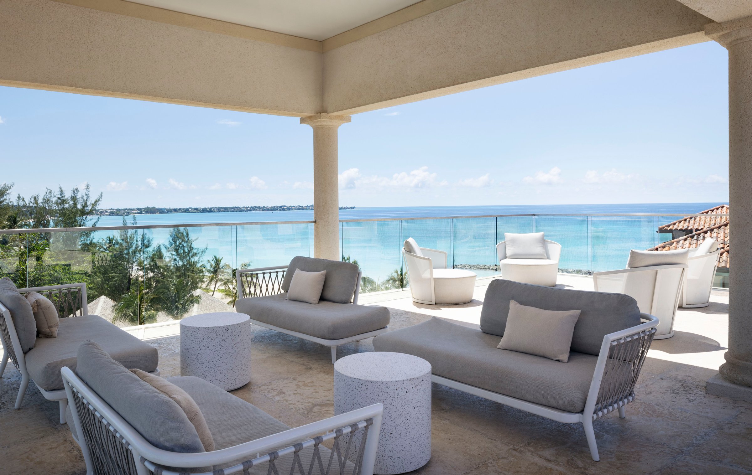 Covered Sky Terrace lounge with sofas overlooking the sea.