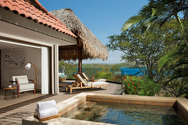 Private villa with plunge pool, lounge chairs, and ocean view at Secrets Papagayo Costa Rica.