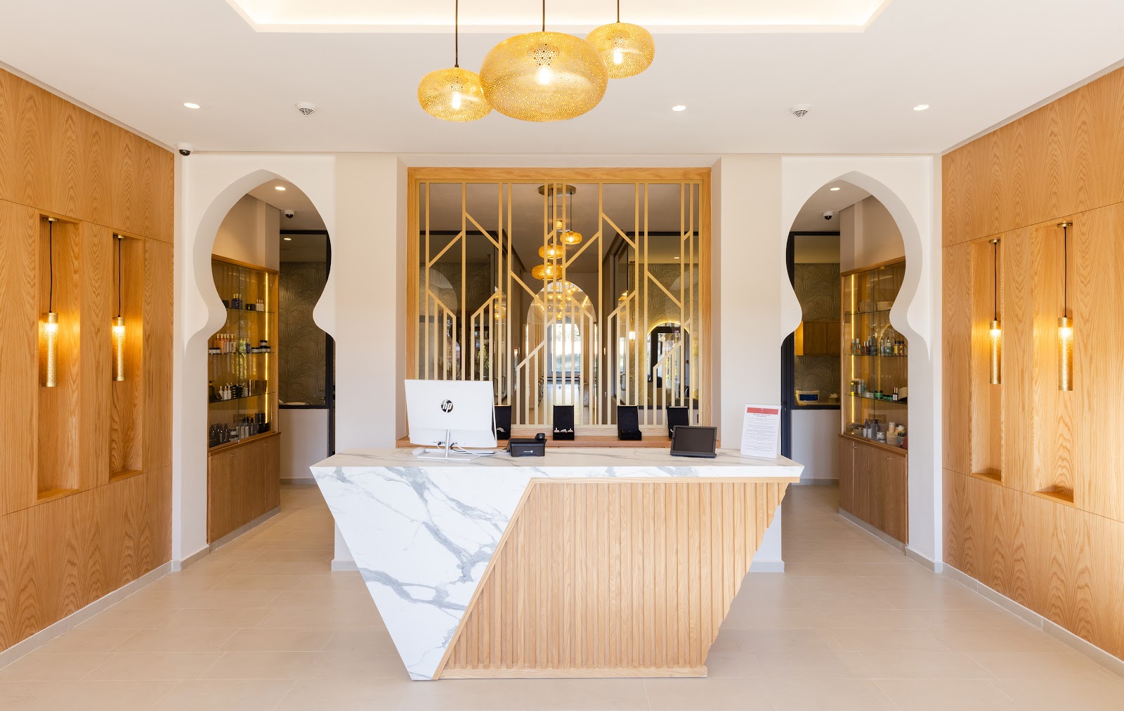 Modern fitness center at Sol Oasis Marrakech with exercise bikes, treadmills, dumbbells, and large windows overlooking countryside.