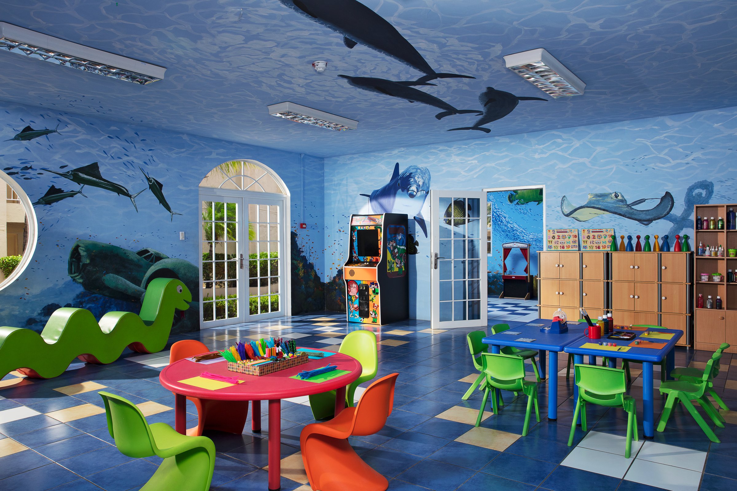 Indoor kids club with underwater mural