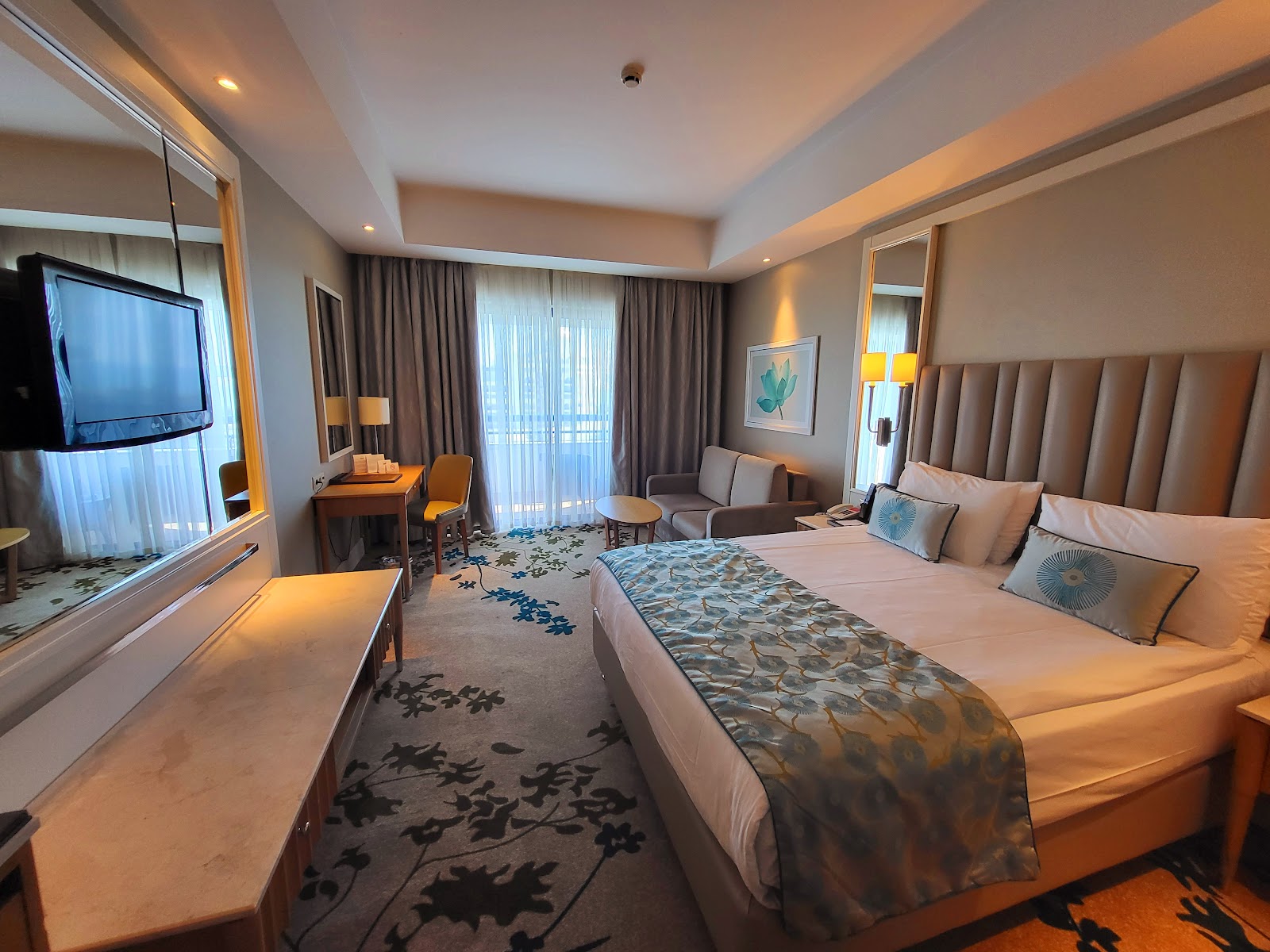 Spa treatment room with two massage beds, a sunken soaking tub, yellow walls, and red accents at Titanic Deluxe Lara.
