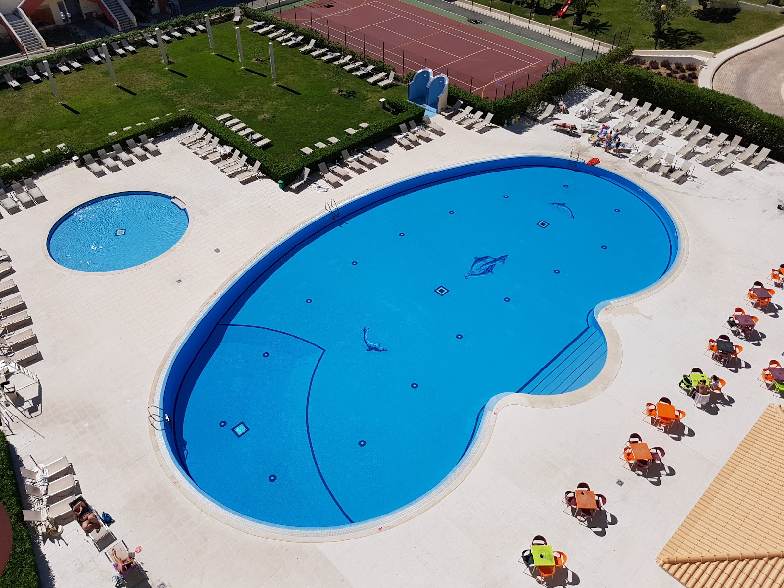 Kids water park with blue slides and sea creature sculptures in shallow pool at Ukino Palmeiras Village.
