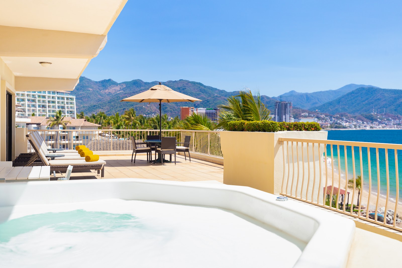 Hot tub on a terrace overlooking the Pacific Ocean, mountains, and Puerto Vallarta skyline at Villa del Palmar Beach Resort & Spa.